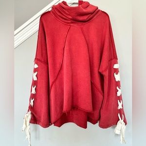 POL One size cowl neck / hooded pullover with lace-up bell sleeves.